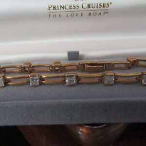 .925 Tennis Bracelet 7" Gold Tone  Prong-set square shaped, multifaceted clear